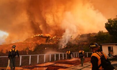 News updates: At least 16 dead in LA fires as dangerous winds could persist; crews douse roads in retardant