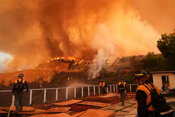 News updates: At least 16 dead in LA fires as dangerous winds could persist; crews douse roads in retardant